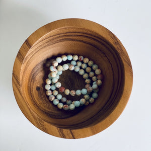 blue agate bracelet in wooden bowl