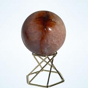 Carnelian sphere on gold metal stand